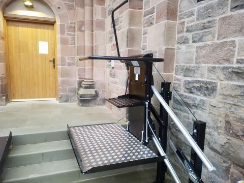 Black outdoor stairlift with glass backing panels.jpg