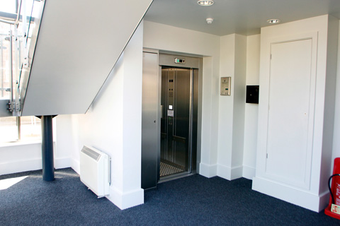 A heavy duty 8 person lift with bump rails and a chequer plate floor