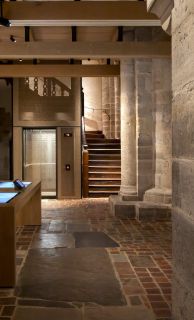 Light-illuminated Stannah passenger lift at Winchester Cathedral