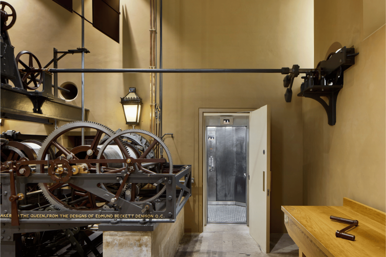 View of bespoke Stannah 13-person passenger lift positioned by clock mechanism at Elizabeth Tower, London