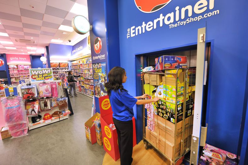 A Stannah trolleylift helps staff move stock between floors in a busy retail shop